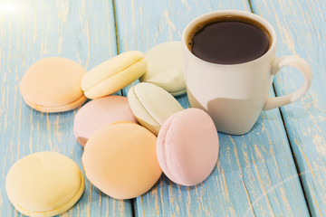 A Cup of coffee with Marshmallows on a light blue background .