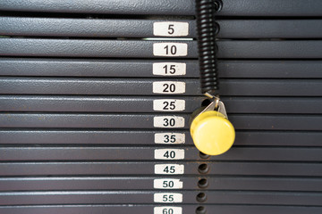 Black metallic or iron heavy plates stacked for sport, exercise, weight machine with kilogram and...