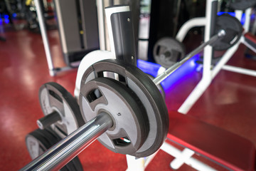 Fototapeta na wymiar Rod and weights in the gym