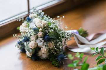 wedding bouquet standing on a window