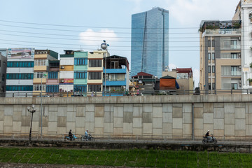 Hanoi buildings with river on clear day in Cau Giay district