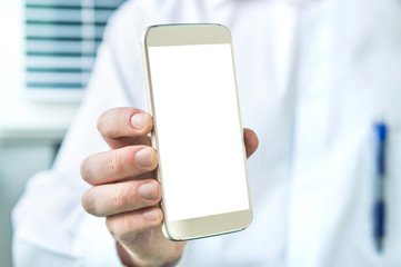 Doctor holding smartphone with empty blank white screen. Medical professional, physician, nurse or dentist showing mobile phone with copy space.
