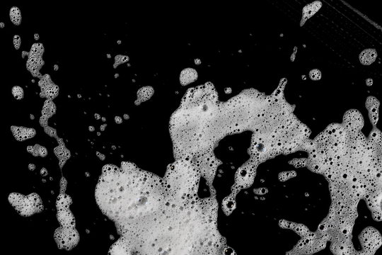 Soap foam, lather isolated on black, with clipping path, texture and background, top view