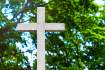 Old stone cross on the background of the setting sun - the concept of the Christian faith