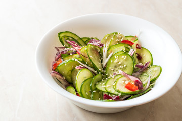 Asian Cucumber Salad with Sesame and served with Chopsticks.