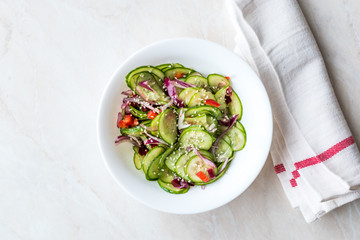 Asian Cucumber Salad with Sesame and served with Chopsticks.