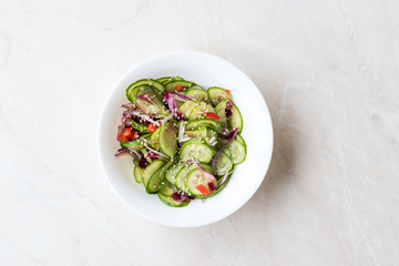 Asian Cucumber Salad with Sesame and served with Chopsticks.