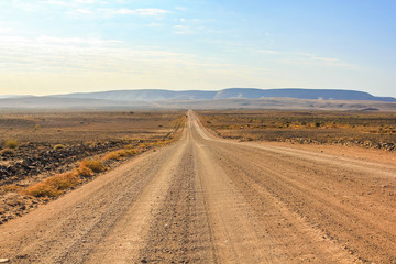 Fototapeta na wymiar Gravel road to the Fish River Canyon, south of Namibia, Africa. Dry season.