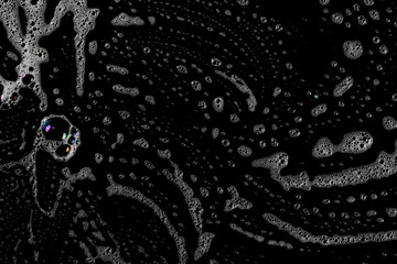 Soap foam, lather isolated on black, with clipping path, texture and background, top view
