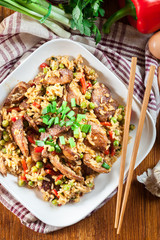 Fried rice with chicken and vegetables served on a plate