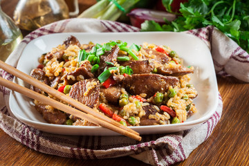 Fried rice with chicken and vegetables served on a plate