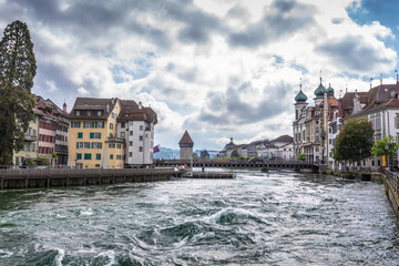 An old European city of Lucerne. Dam with waterfalls on a mountain lake.