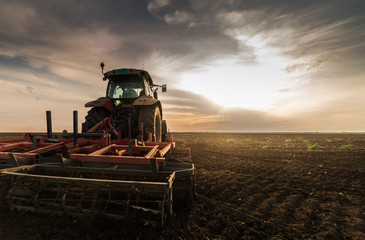 Tractor plowing fields -preparing land for sowing in autumn