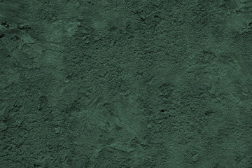 dark green concrete uneven cracked background.