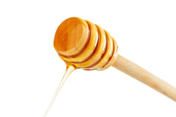 honey with wooden drizzler isolated on white background