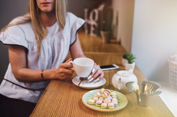 Young Happy Woman Drinking Green Tea in  a cafe