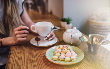 Beautiful girl with hot drink relaxing in  a cafe 