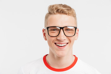 Image closeup of blond teenage guy having clean healthy skin wearing eyeglasses smiling at camera...