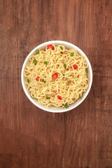 Overhead photo of noodles with chili peppers and place for text