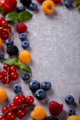 Various fresh summer Berries on the Gray Background.Mix Berries.Food or Healthy diet concept.Super Food.Vegetarian.Top View.Copy space for Text.selective focus.