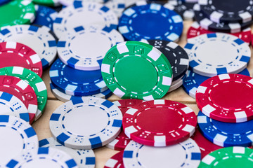 Colourful casino chips on the table closeup