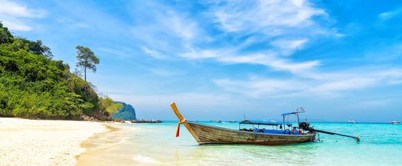Amazing view of beautiful beach with traditional thailand longtale boat. Location: Bamboo island,...