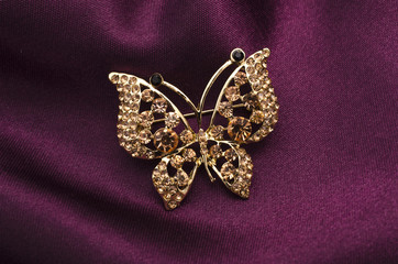 brooch butterfly with diamonds isolated on silk