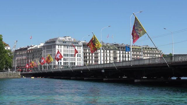 GENEVA, SWITZERLAND - JULY 06, 2017: Geneva bridge and Swiss flags.