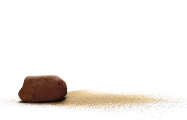 Red stone in sand pile isolated on white background
