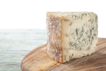 Wedge of Stilton Cheese on a Cheeseboard