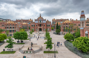 Fototapeta premium BARCELONA, SPAIN - MAY 12, 2018: People visit Recinte Modernista de Sant Pau. The city attracts 10 million tourists annually