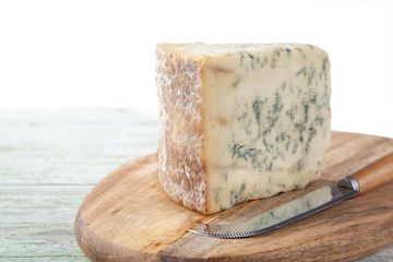 Wedge of Stilton Cheese on a Cheeseboard