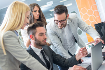 Business team working together on laptop in the office