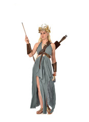 full length portrait of pretty blonde lady wearing fantasy toga gown,  and holding a bow and arrow. standing pose on white background.