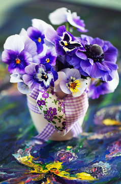 Photo of a beautiful pansy flowers close-up on a painted background. Beautiful and delicate flowers. 