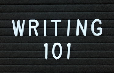 The words Writing 101 in white plastic letters on a black letter board as an introduction to writing skills for authors 