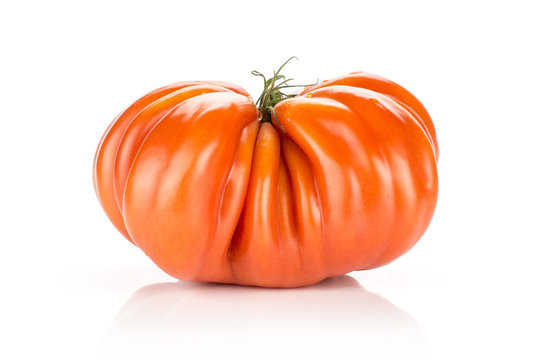 Beef tomato isolated on white background one big ripe red ribbing.