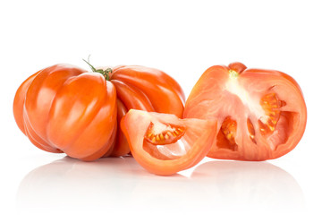 One beef tomato with section half and a slice set isolated on white background big ripe red flesh with seeds.