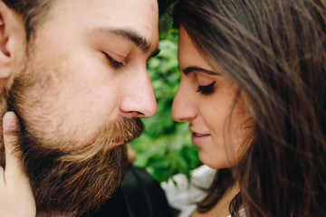 Concept of love relationship. Lovely happy couple. Amazing beautiful woman and handsome man. Romantic bearded boy and girl outdoor together. Man and girl are happy and enjoy each other.