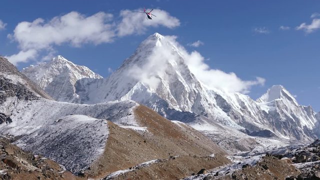 Helicopter flight over the Solu Khumbu valley towards the base camp of the Everest peak.