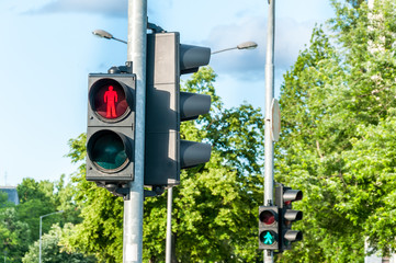 Red traffic light signal for pedestrians on the crosswalk in the city