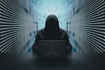 Anonymous hacker in front of his computer