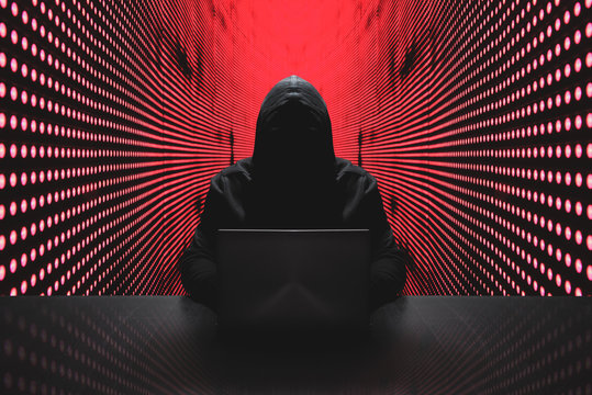 Anonymous hacker in front of his computer