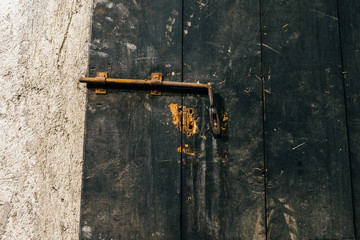 Close up view of iron lock on an weathered wooden door