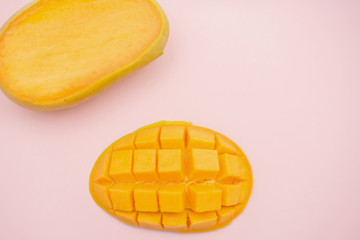 fresh ripe mango and copy space for text on pink background