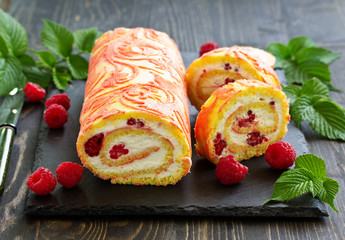 Sponge roulade with raspberries and cream.