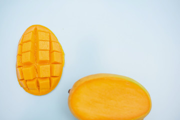 fresh ripe mango and copy space for text on blue background
