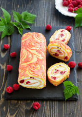 Sponge roulade with raspberries and cream.