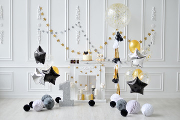 One year birthday decorations. Decorations for holiday party. A lot of balloons black and Gold colors. 