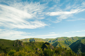 Summer day landscape of the mountain locality of the Caucasus and a view of the sky. Travel and the environment.